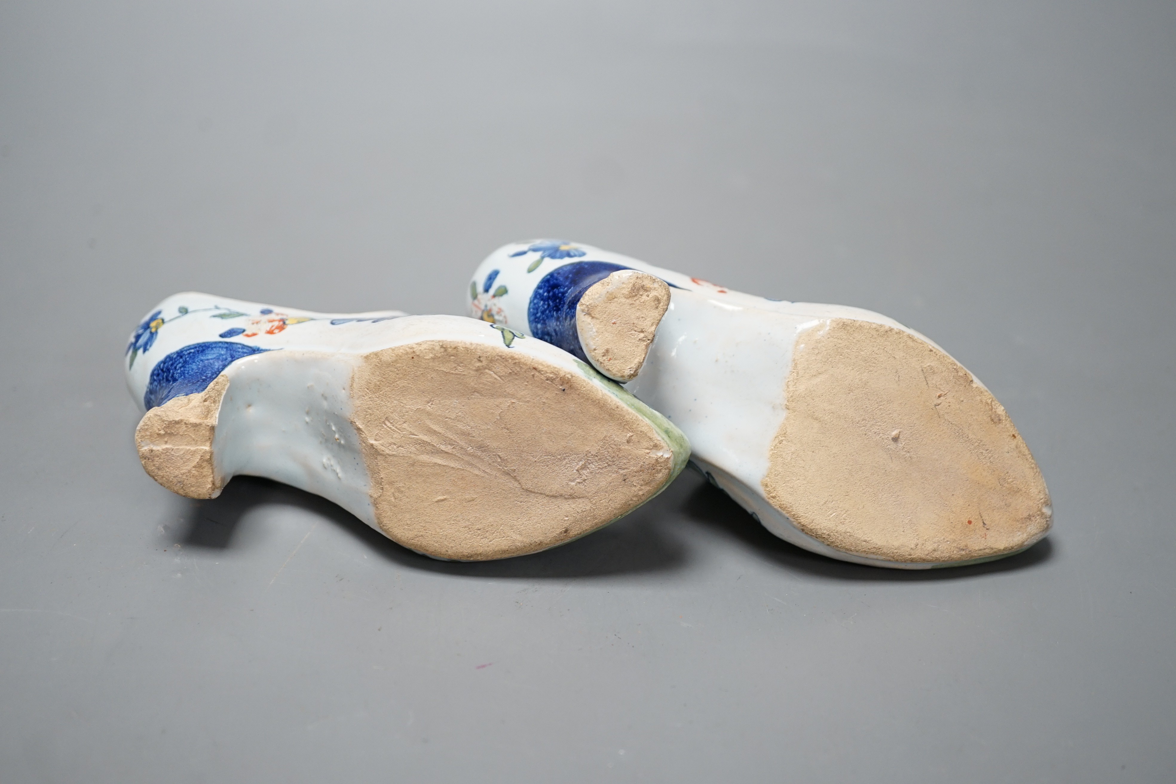 A pair of 19th century Delft polychrome models of shoes, 14cms wide